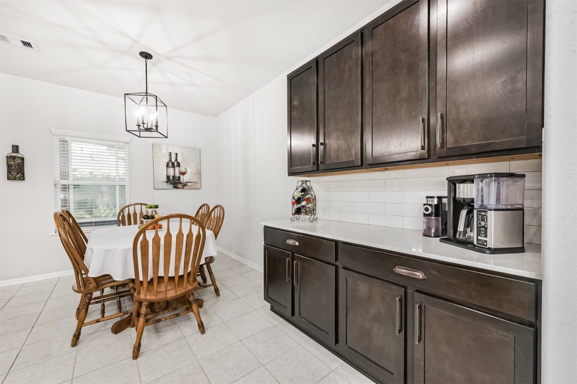 10018 Chase Court Baytown, TX 77521 - Photo 14 of 46 a kitchen with a dining table chairs cabinets and stainless steel appliances