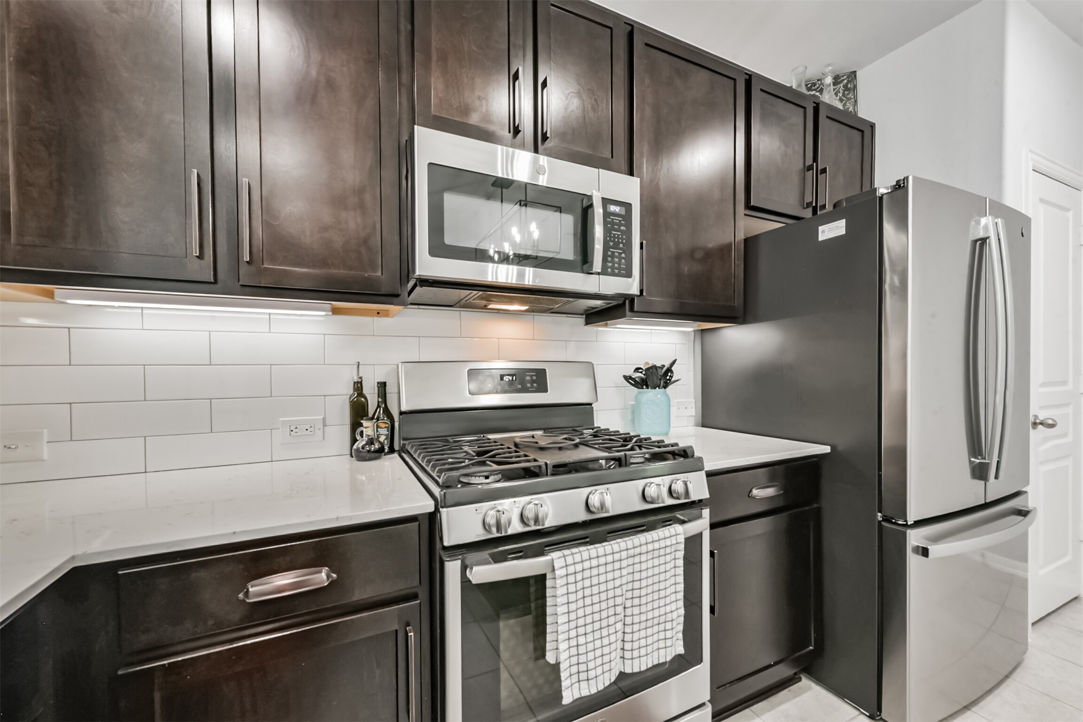 10018 Chase Court Baytown, TX 77521 - Photo 15 of 46 a kitchen with granite countertop stainless steel appliances and wooden cabinets