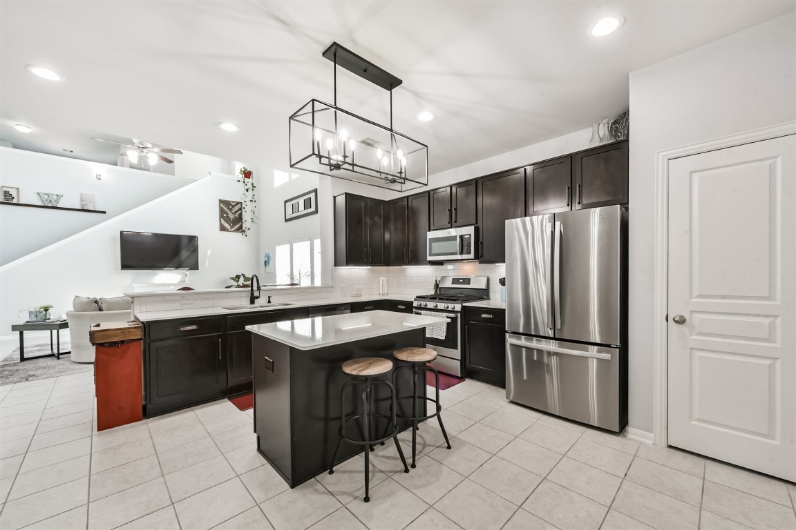 10018 Chase Court Baytown, TX 77521 - Photo 2 of 46 a kitchen with stainless steel appliances granite countertop a sink and a refrigerator