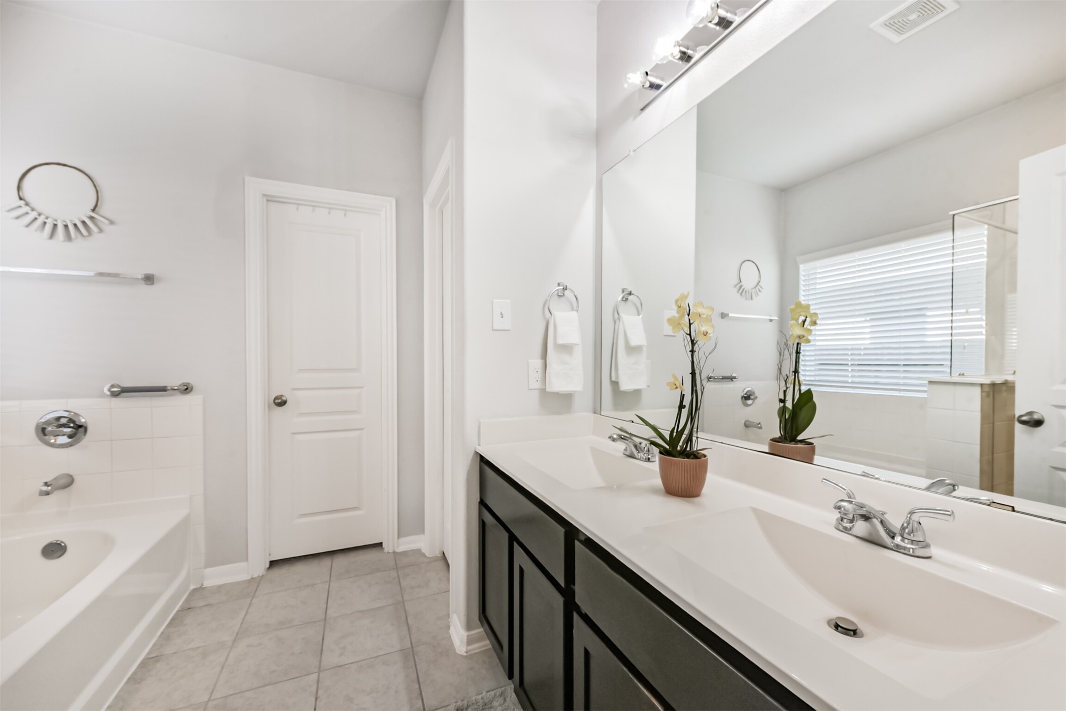 10018 Chase Court Baytown, TX 77521 - Photo 22 of 46 a bathroom with a double vanity sink a tub and shower