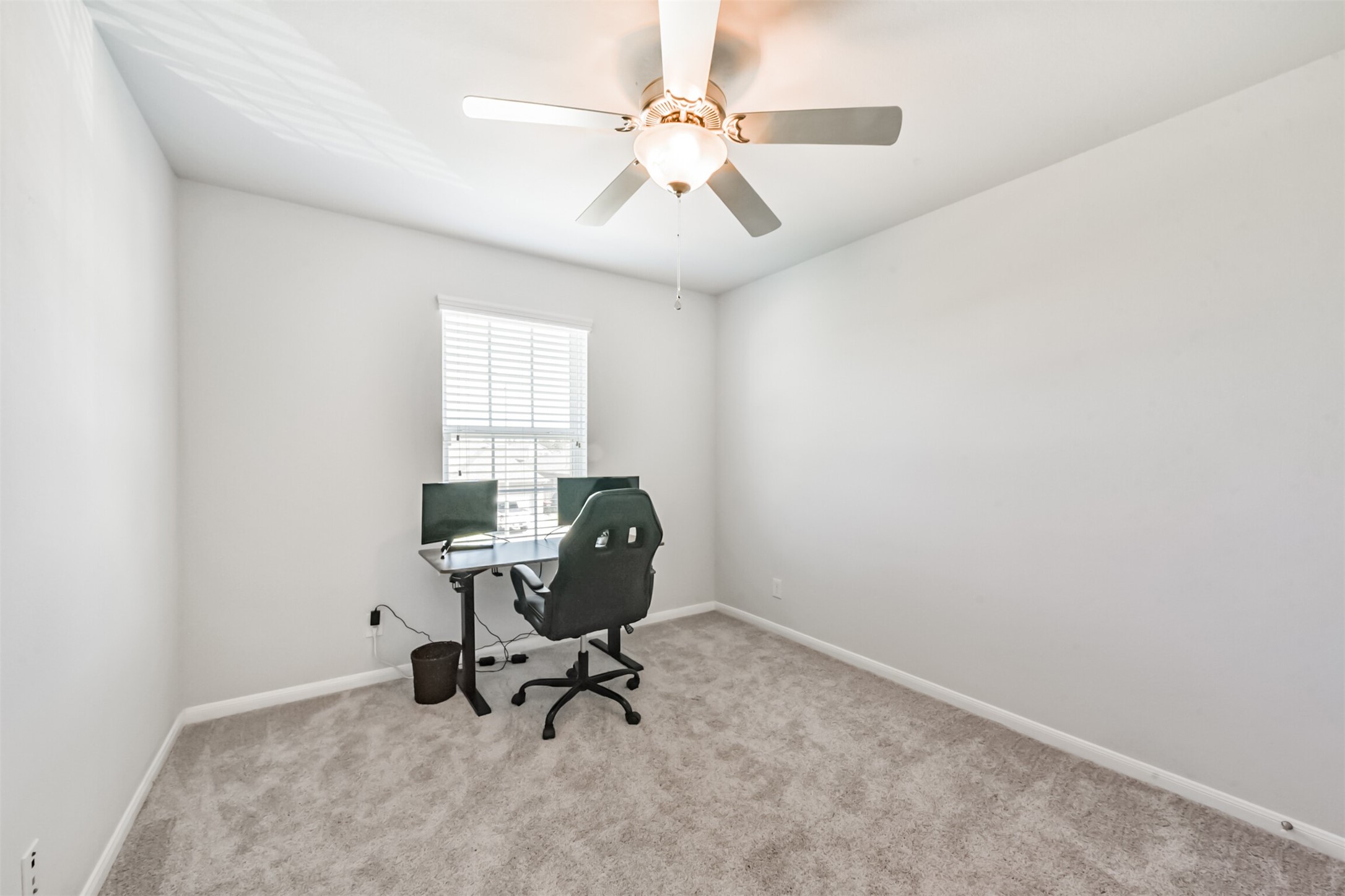 10018 Chase Court Baytown, TX 77521 - Photo 29 of 46 a view of a workspace with furniture and a window