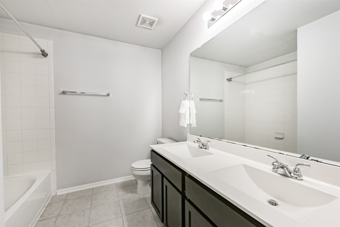 10018 Chase Court Baytown, TX 77521 - Photo 31 of 46 a bathroom with a sink a toilet and shower