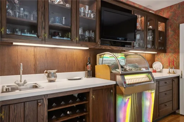 a kitchen with a sink and a stove top oven