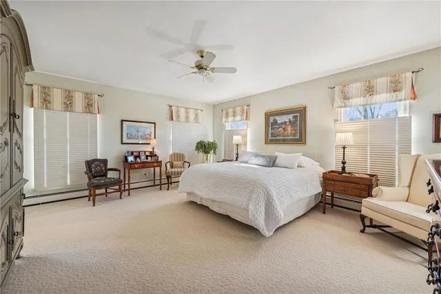 a spacious bedroom with a bed and a couch