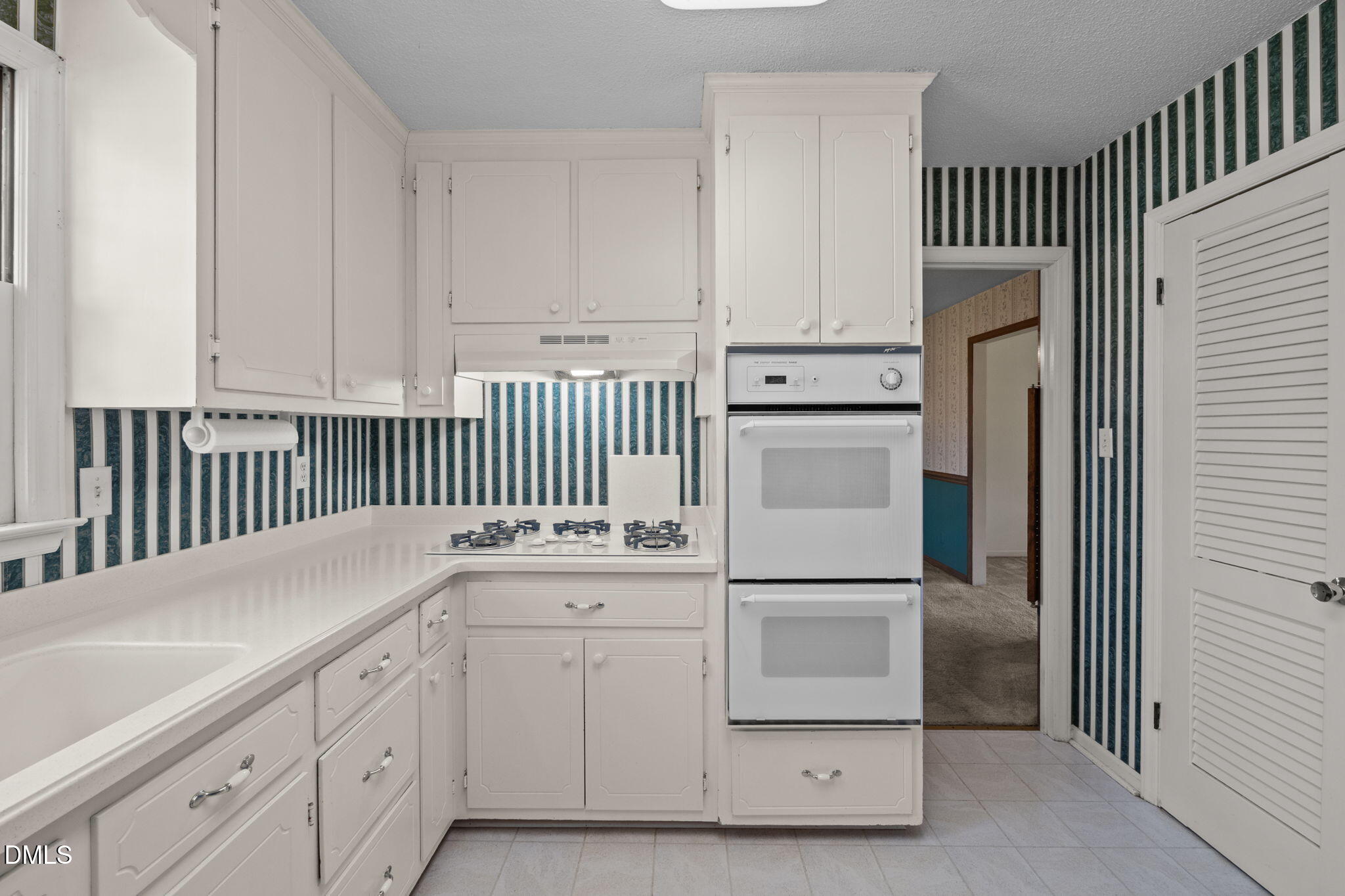 2421 Bonnie Brae Road Durham, NC 27703 - Photo 15 of 55 a kitchen with white cabinets and refrigerator