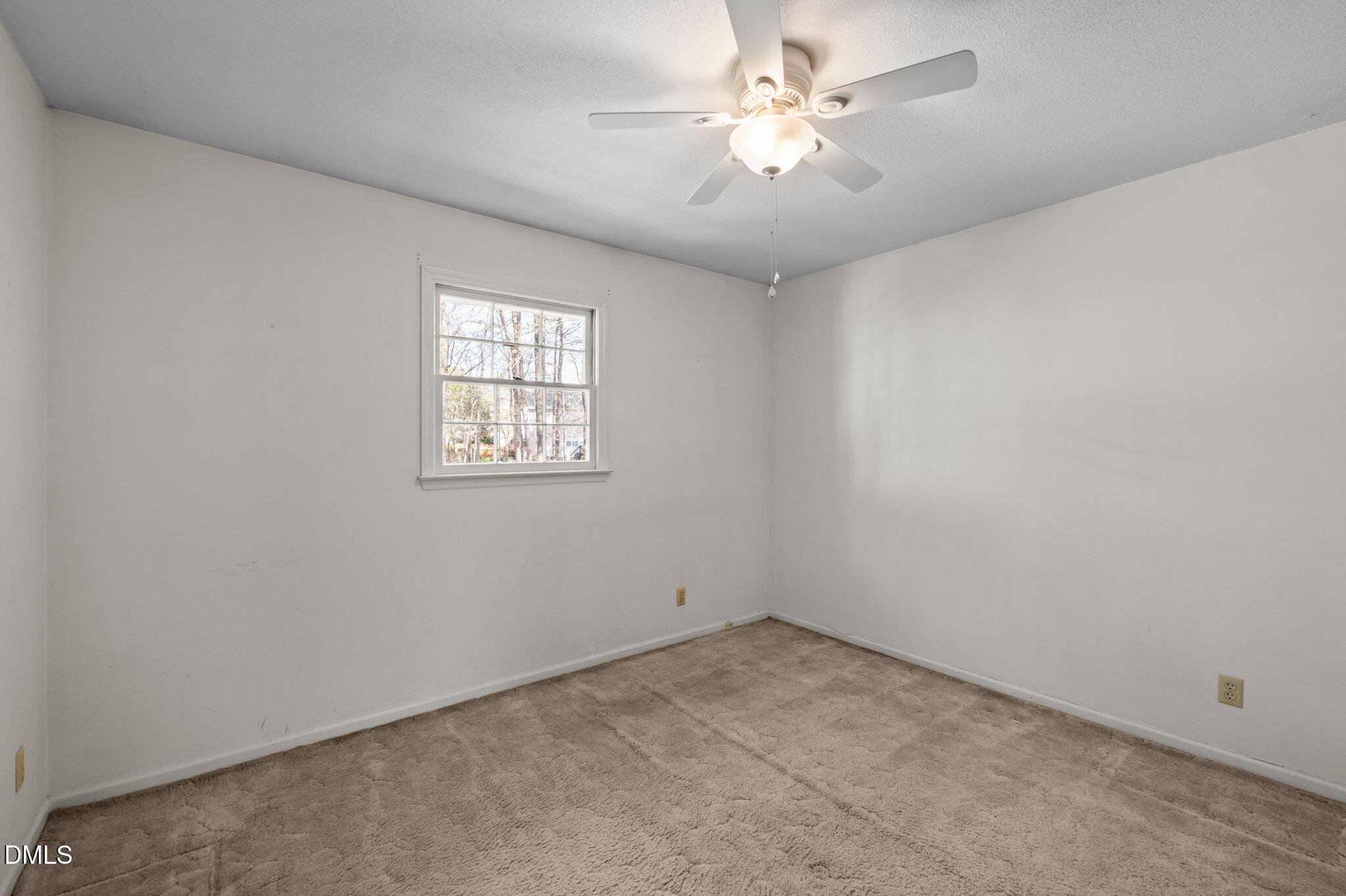 2421 Bonnie Brae Road Durham, NC 27703 - Photo 26 of 55 an empty room with a window and a fan
