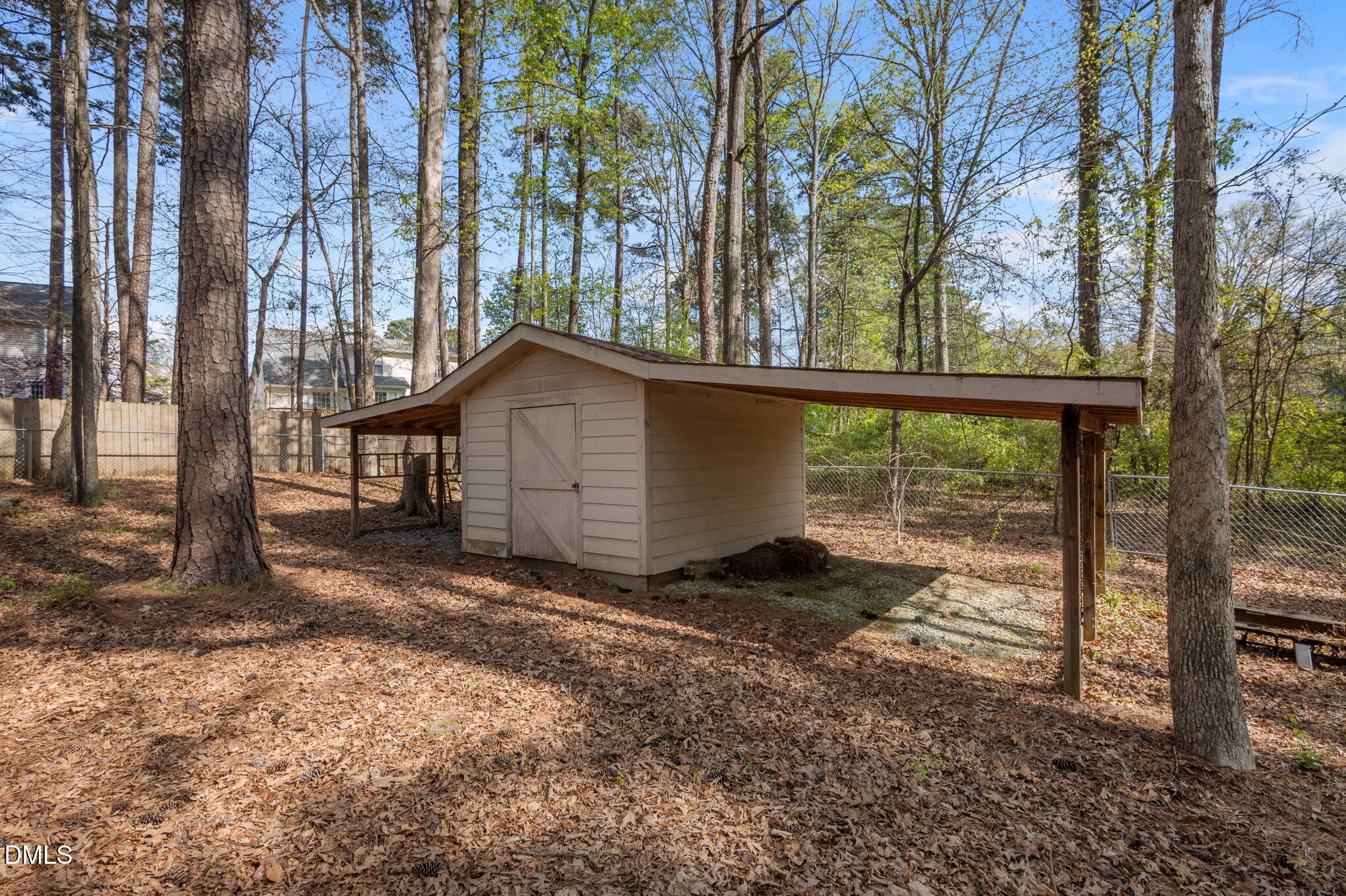2421 Bonnie Brae Road Durham, NC 27703 - Photo 39 of 55 a view of a backyard with large trees and wooden fence