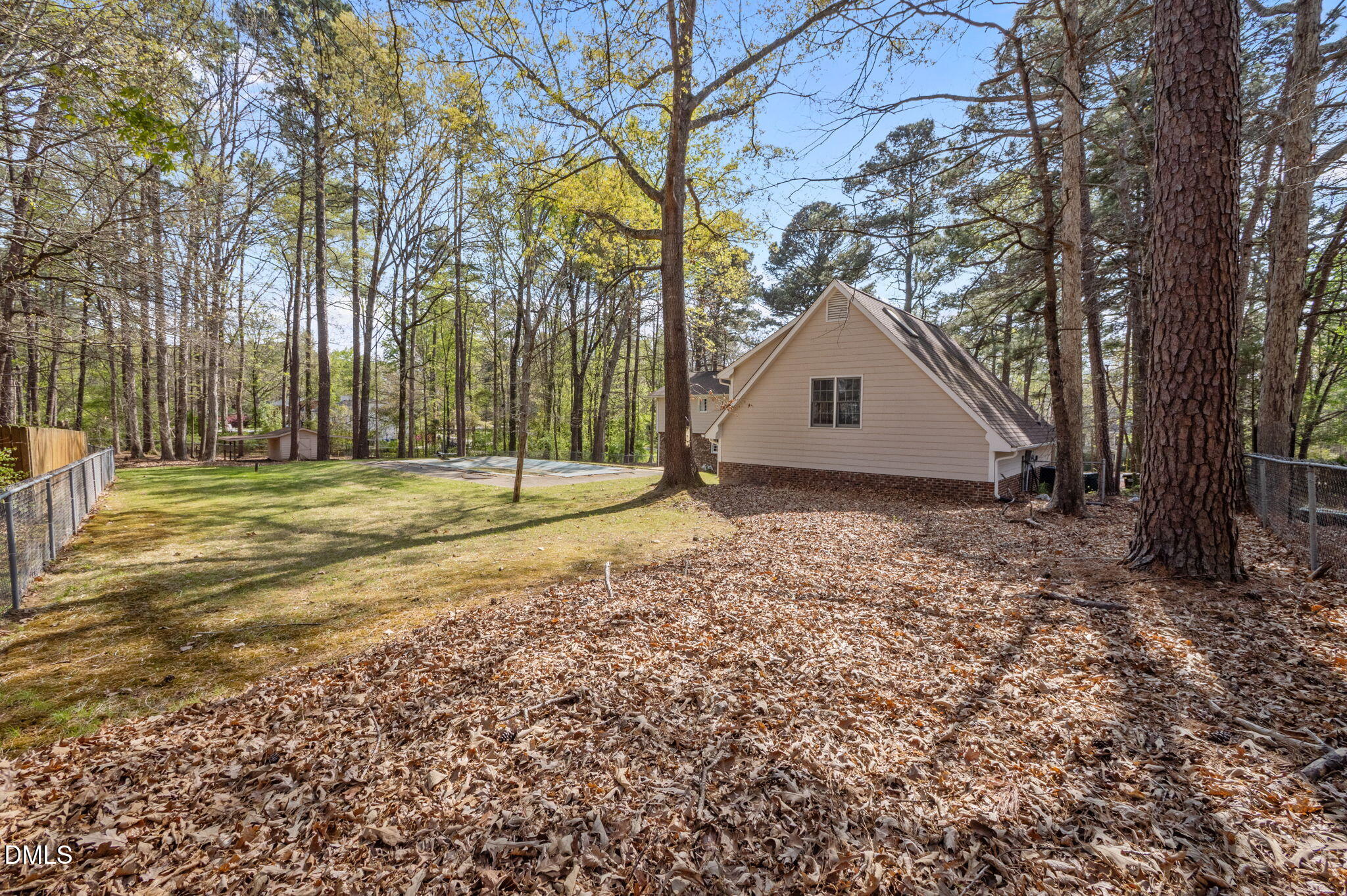 2421 Bonnie Brae Road Durham, NC 27703 - Photo 44 of 55 a view of backyard with large trees and wooden fence
