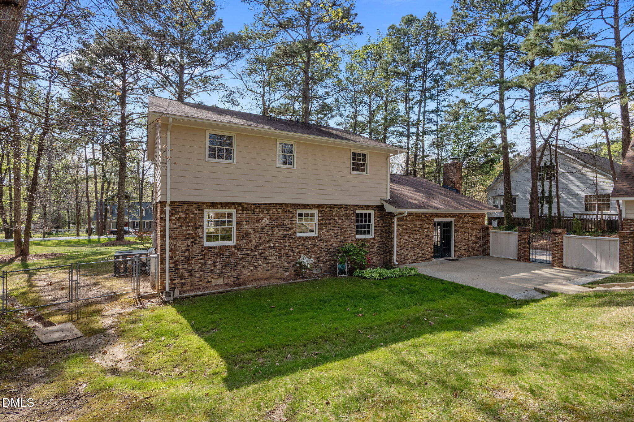 2421 Bonnie Brae Road Durham, NC 27703 - Photo 47 of 55 a view of a backyard with table and chairs and a large tree