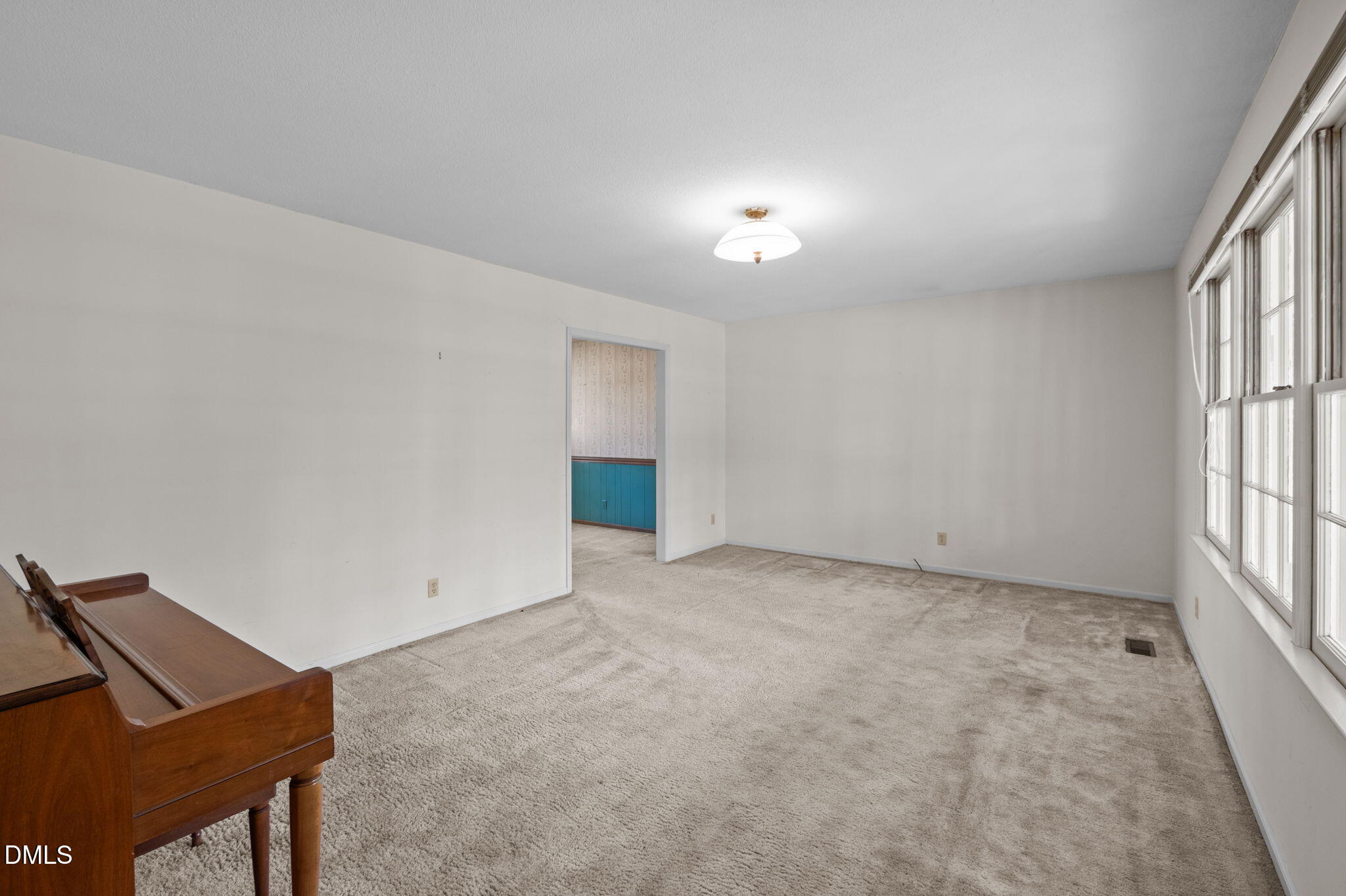 2421 Bonnie Brae Road Durham, NC 27703 - Photo 10 of 55 an empty room with windows and cabinet