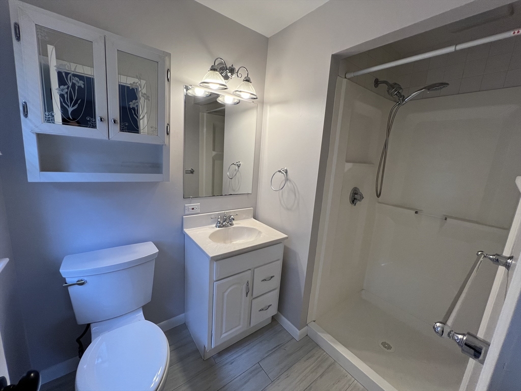 27 Miles Standish Drive, Unit 27 Marlborough, MA 01752 - Photo 15 of 22 a bathroom with a toilet sink and mirror