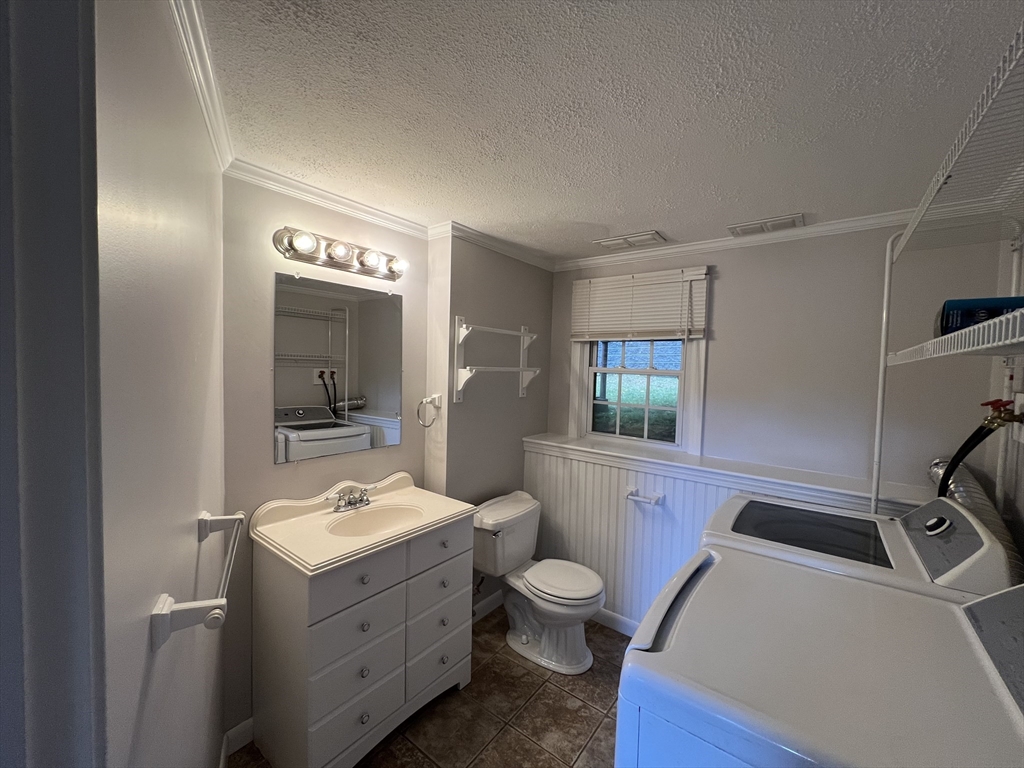 27 Miles Standish Drive, Unit 27 Marlborough, MA 01752 - Photo 20 of 22 a bathroom with a sink a toilet and mirror