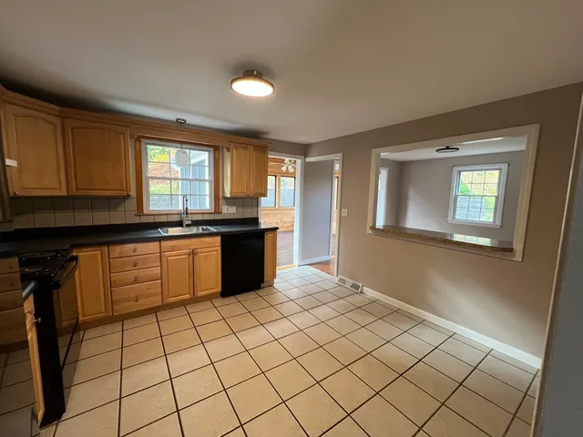 a kitchen with stainless steel appliances granite countertop a sink and cabinets
