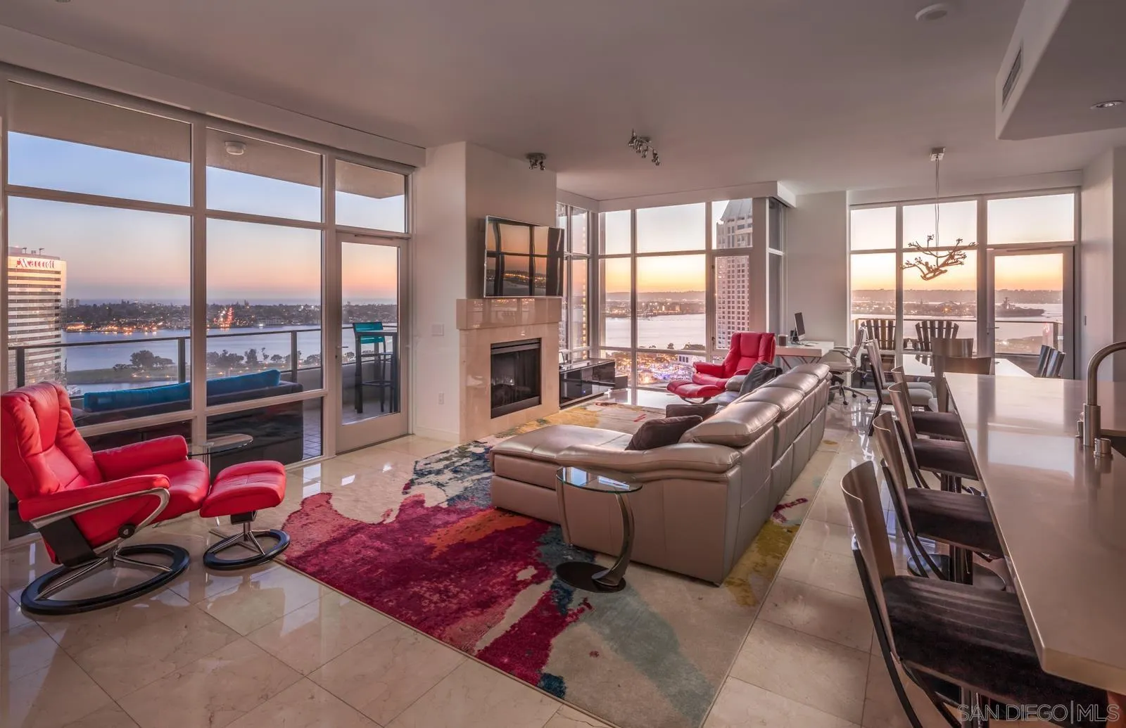 a living room with furniture and floor to ceiling windows