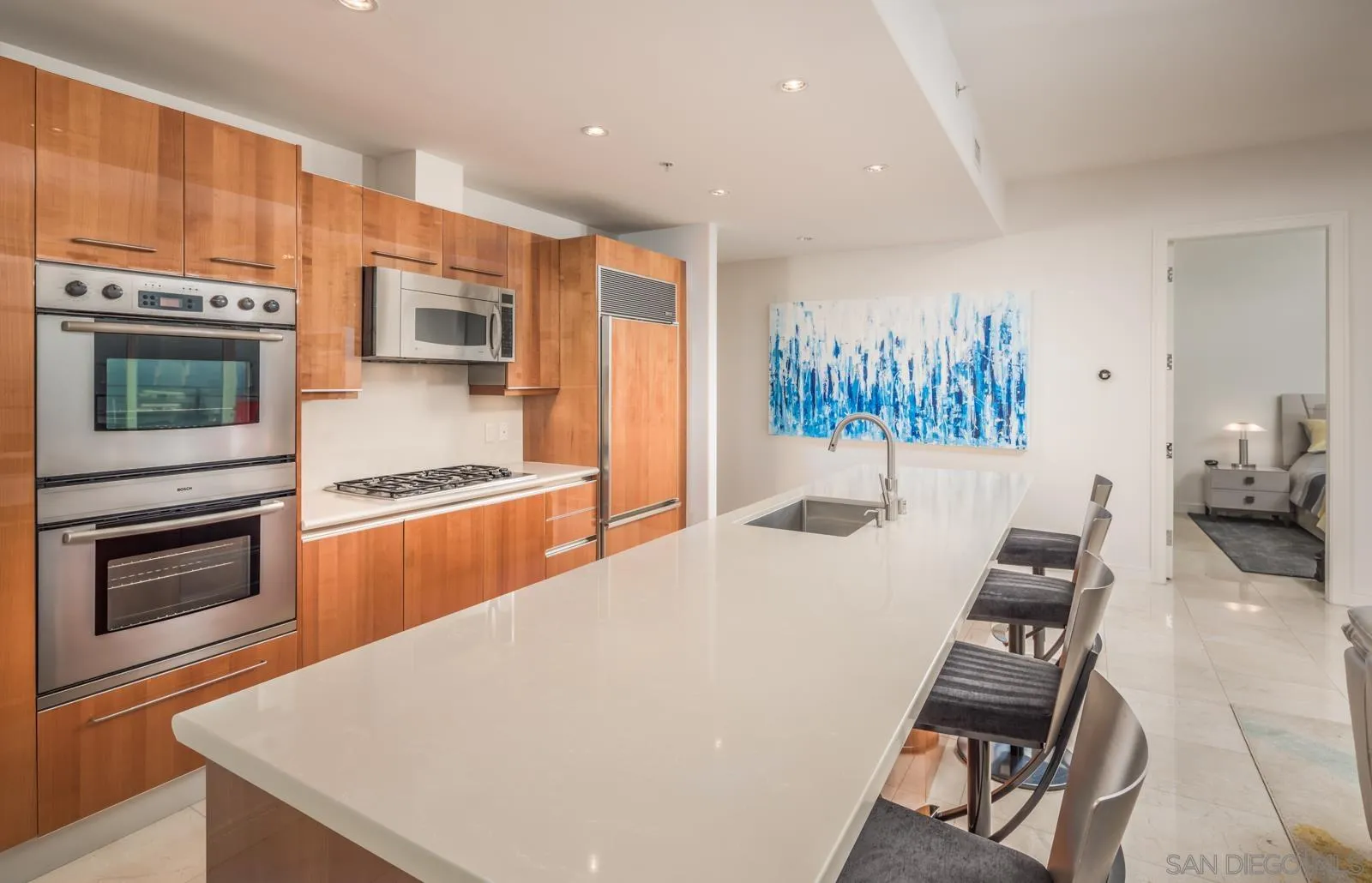 550 Front Street, Unit 1908 San Diego, CA 92101 - Photo 10 of 27 a kitchen with stainless steel appliances a stove a refrigerator a sink a stove and island