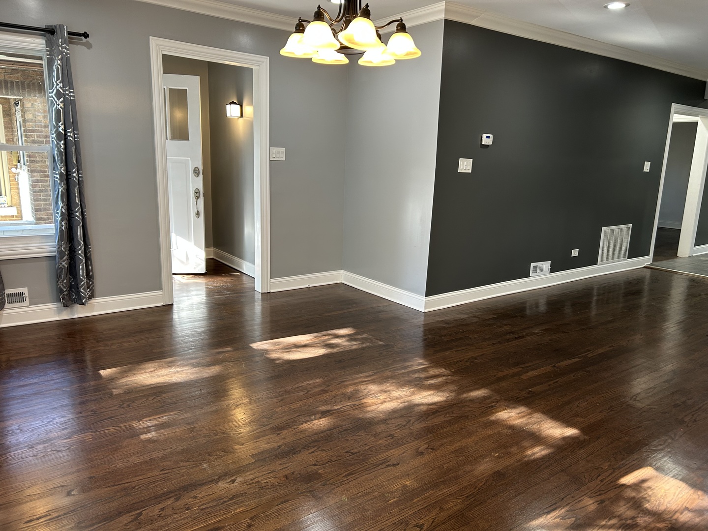 4858 West Concord Place, Unit 1 Chicago, IL 60639 - Photo 3 of 14 a view of an empty room with wooden floor and a large window