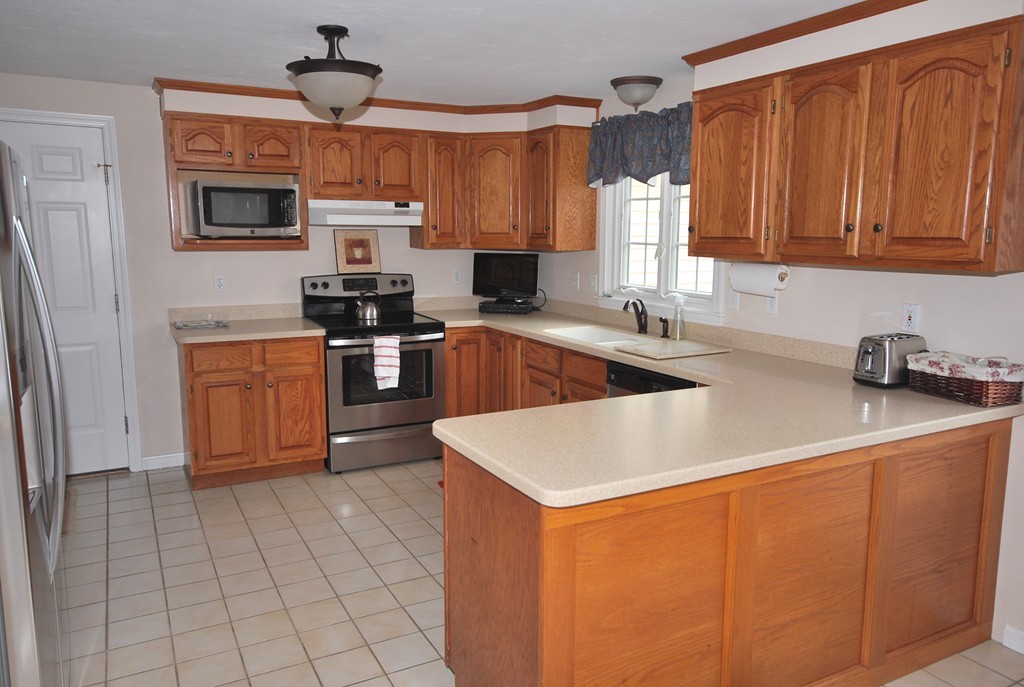36 Central Tree Road Rutland, MA 01543 - Photo 8 of 26 a kitchen with stainless steel appliances granite countertop a sink a stove and a refrigerator
