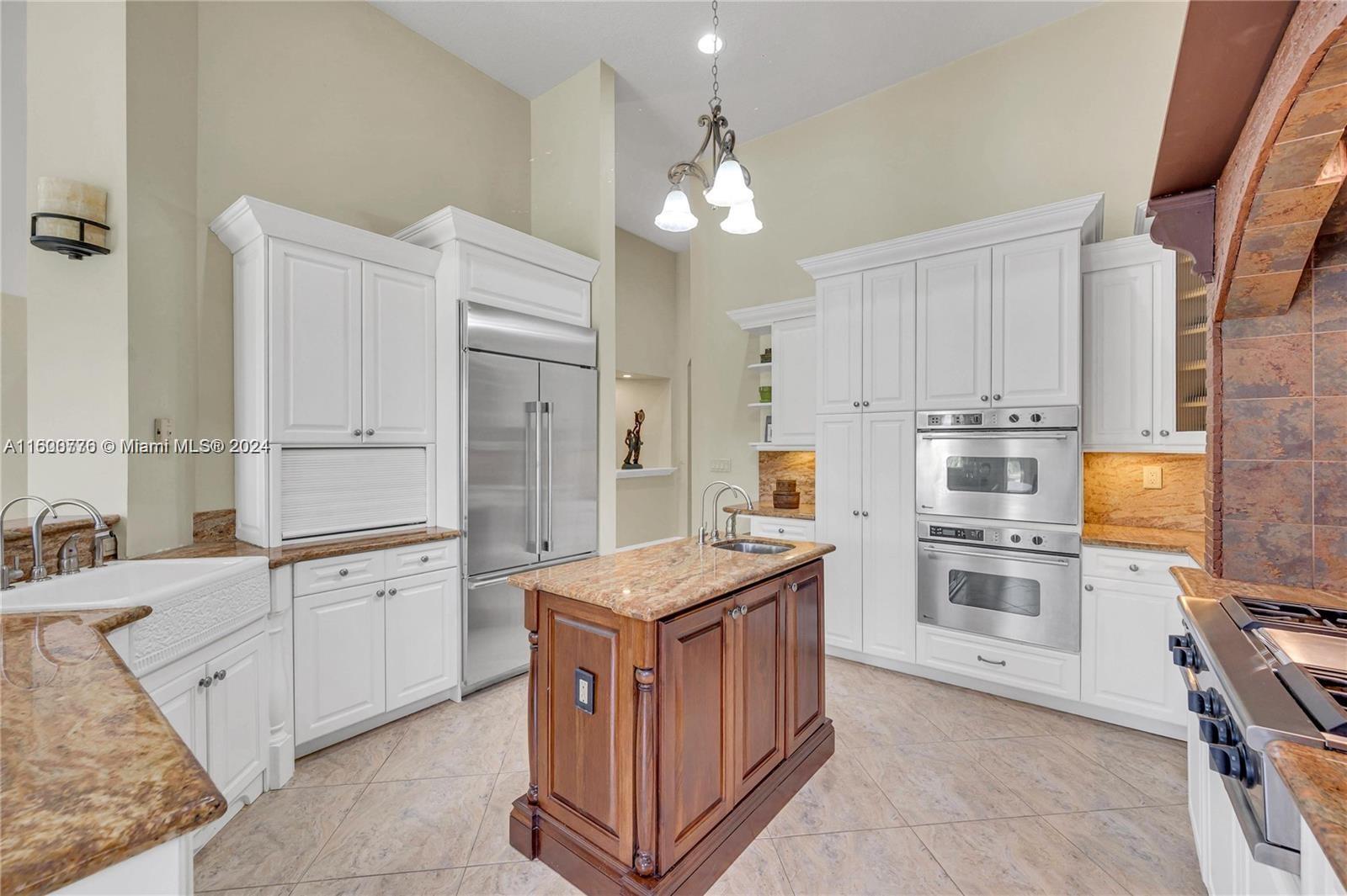 10901 Southwest 91st Street Miami, FL 33176 - Photo 15 of 69 a kitchen with kitchen island cabinets and refrigerator