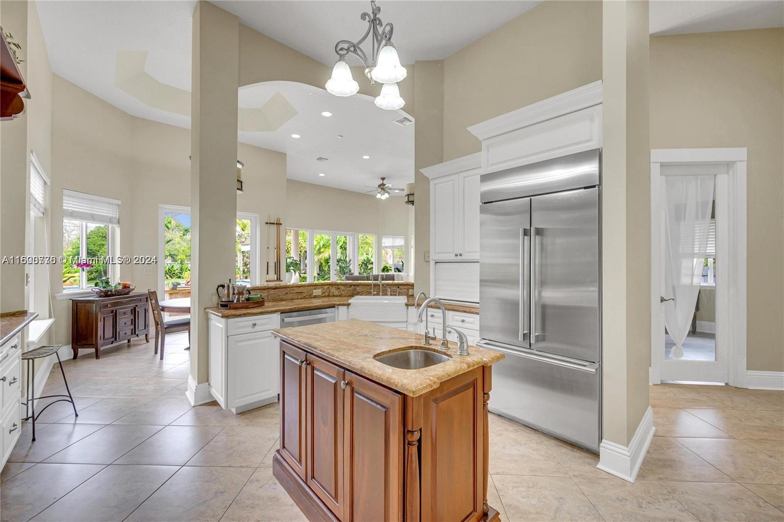 10901 Southwest 91st Street Miami, FL 33176 - Photo 16 of 69 a kitchen with a refrigerator a sink and a stove