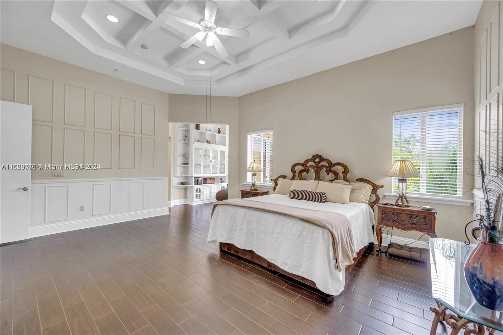 10901 Southwest 91st Street Miami, FL 33176 - Photo 24 of 69 a spacious bedroom with a bed and a table in it