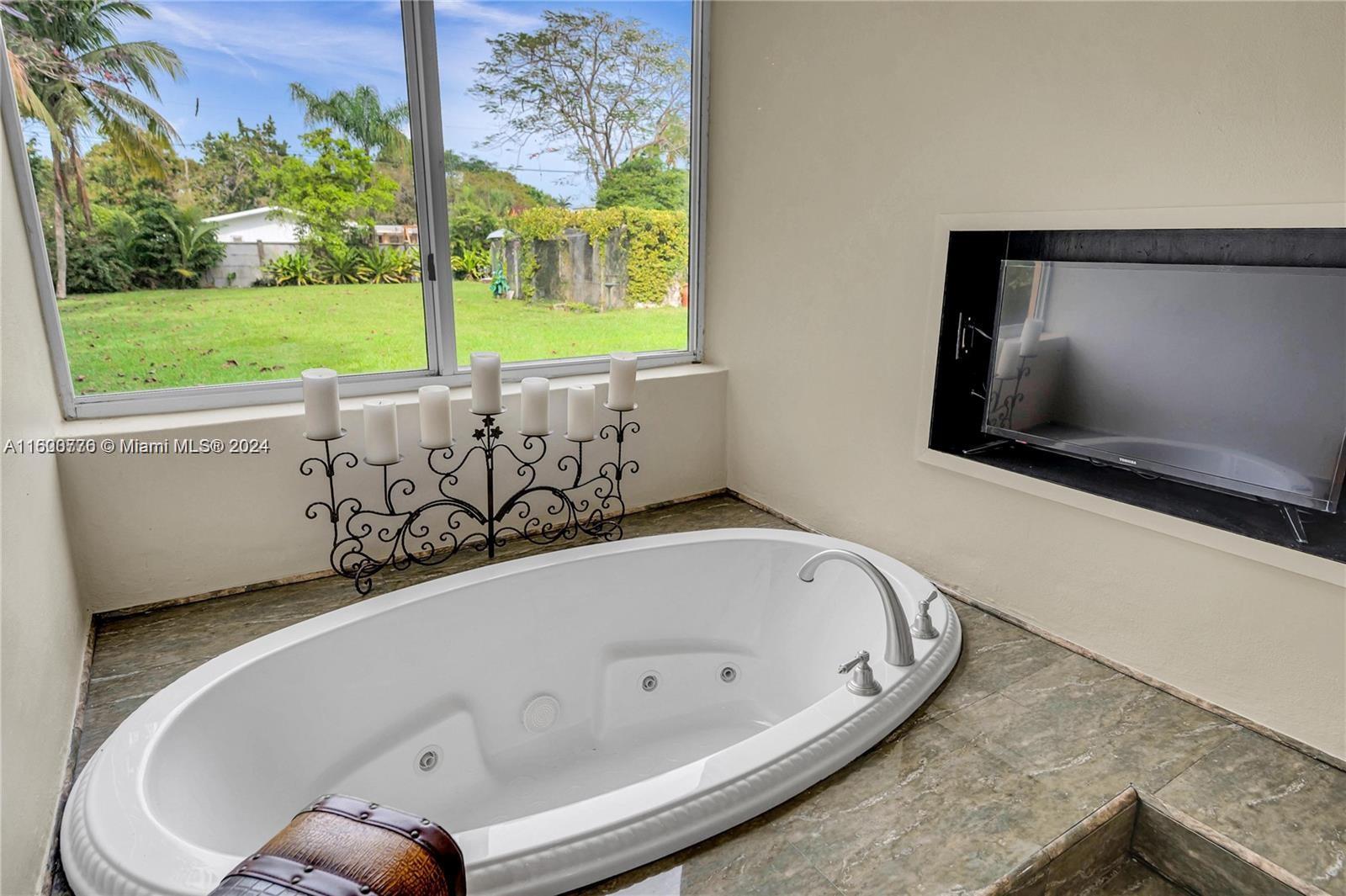 10901 Southwest 91st Street Miami, FL 33176 - Photo 35 of 69 a bathroom with a bathtub and a window