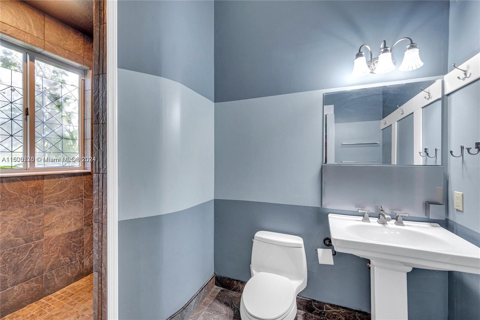 10901 Southwest 91st Street Miami, FL 33176 - Photo 40 of 69 a bathroom with a sink a toilet and a mirror