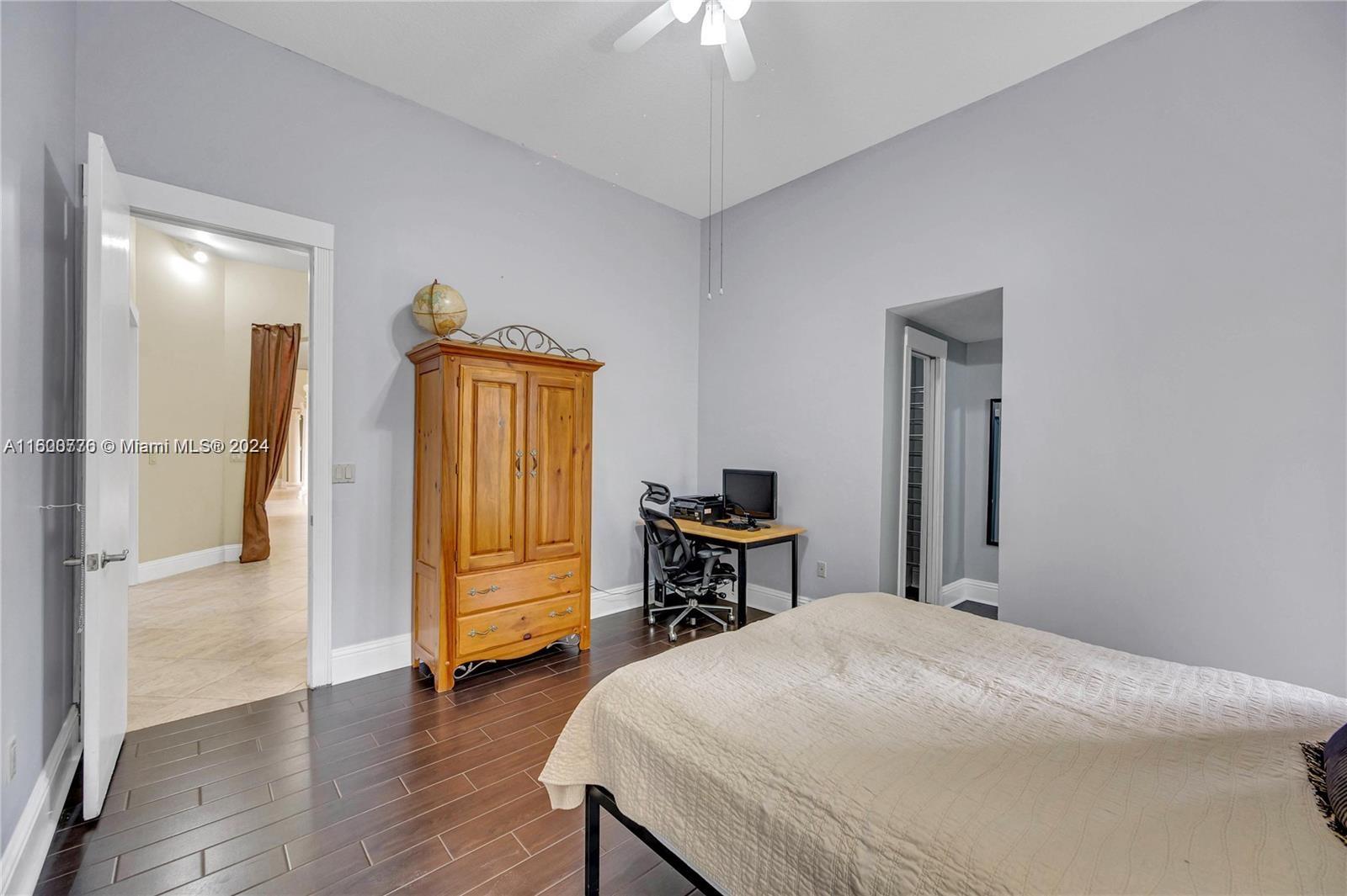 10901 Southwest 91st Street Miami, FL 33176 - Photo 41 of 69 a bedroom with a bed and a chandelier