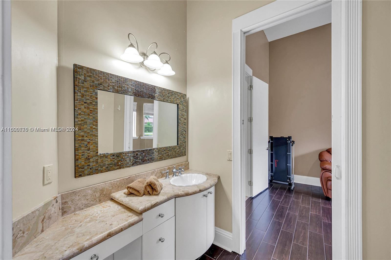 10901 Southwest 91st Street Miami, FL 33176 - Photo 43 of 69 a bathroom with a sink and a mirror