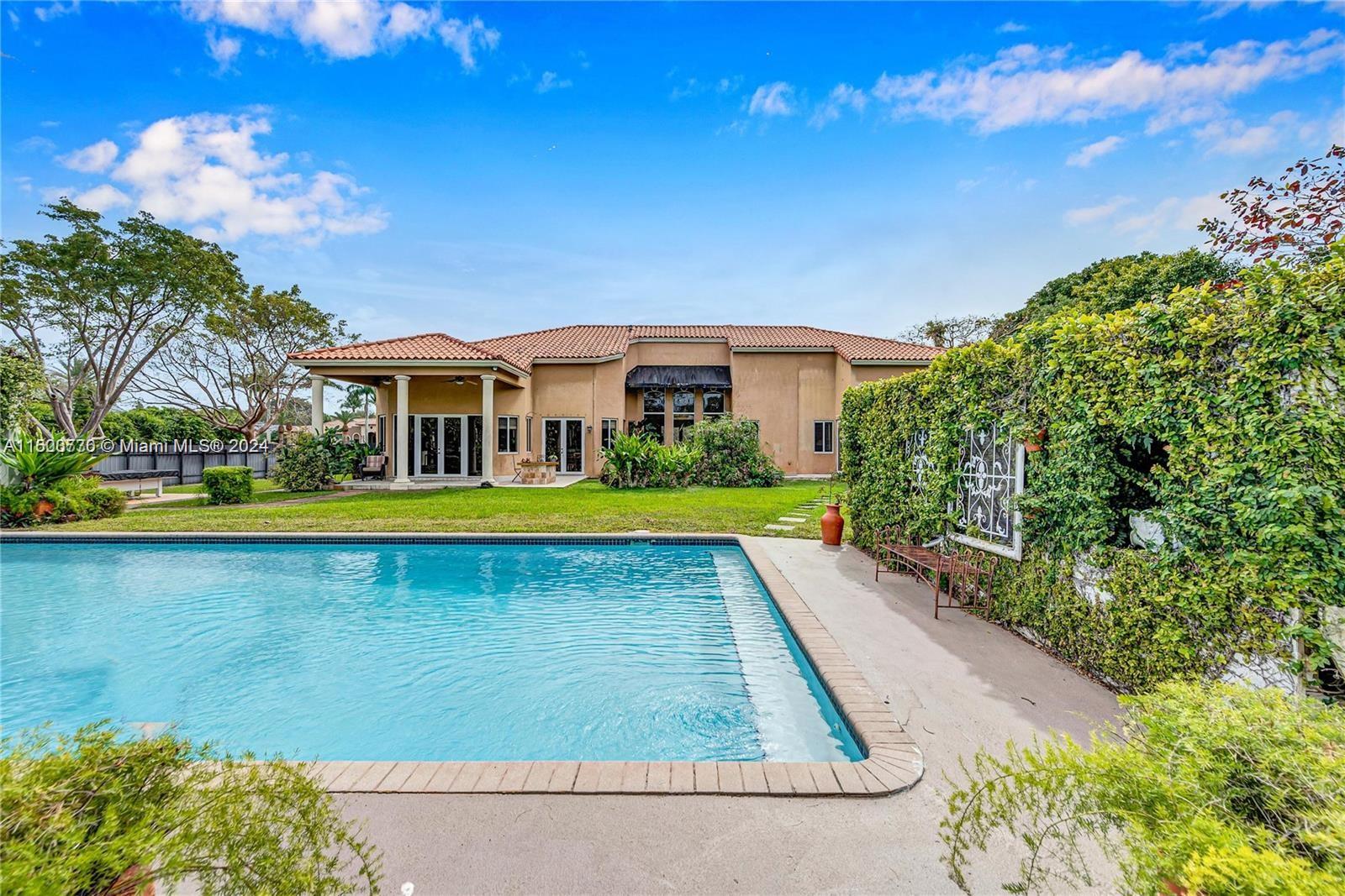 10901 Southwest 91st Street Miami, FL 33176 - Photo 48 of 69 a view of swimming pool with outdoor seating and house in the background