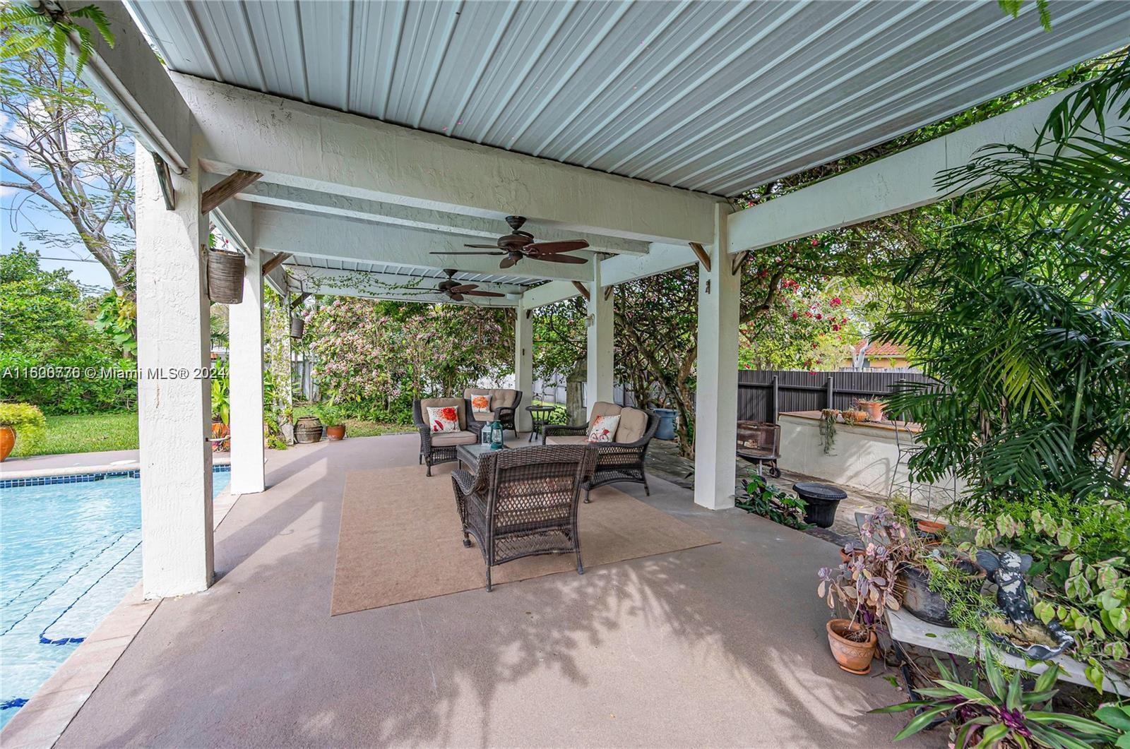 10901 Southwest 91st Street Miami, FL 33176 - Photo 56 of 69 a view of a patio with table and chairs and potted plants