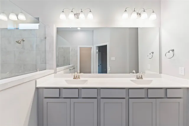a bathroom with a sink vanity and a mirror