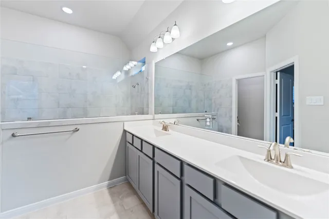 a bathroom with a double vanity sink and mirror