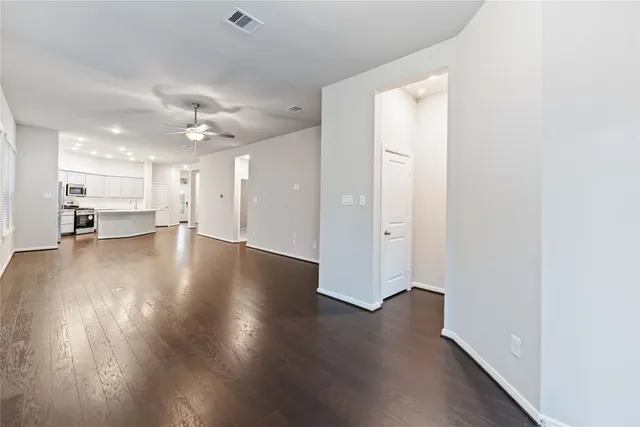 a view of a hallway with wooden floor