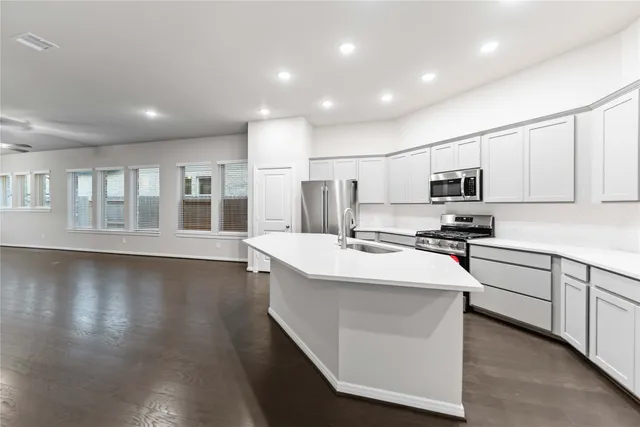 a kitchen with counter top space cabinets and appliances