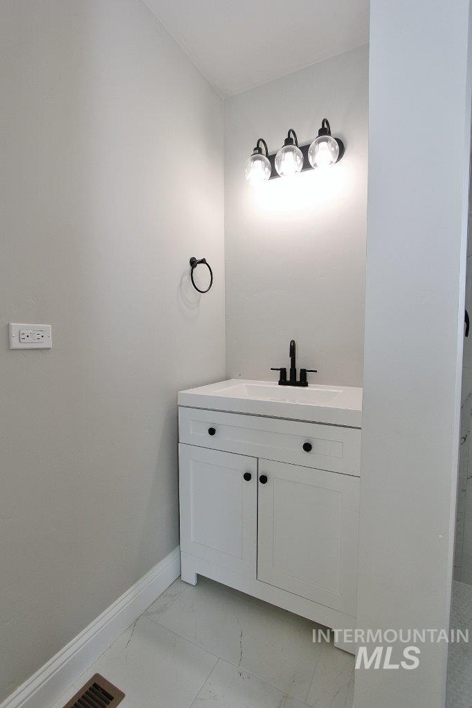 121 Northwest 2nd Street Ontario, OR 97914 - Photo 21 of 32 Bathroom featuring vanity and light marble finish flooring