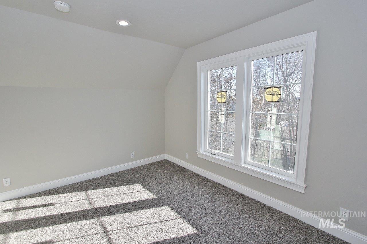 121 Northwest 2nd Street Ontario, OR 97914 - Photo 25 of 32 Additional living space with lofted ceiling, carpet, and recessed lighting