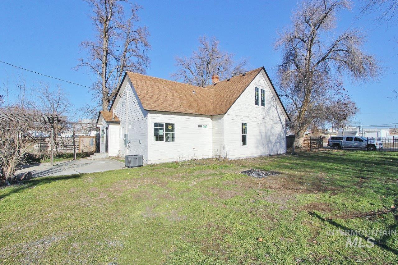 121 Northwest 2nd Street Ontario, OR 97914 - Photo 32 of 32 Rear view of property with roof with shingles, a patio area, and a chimney