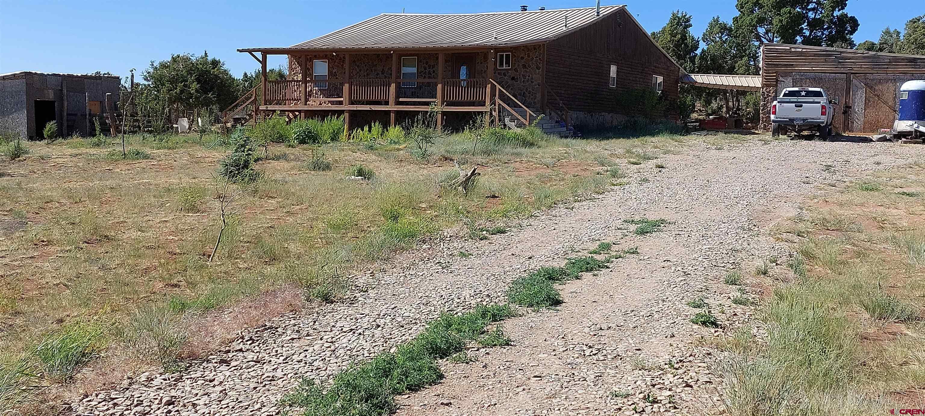 14663 Road N 3 Cahone Co 81320 Cahone, CO 81320 - Photo 1 of 20 a view of a house with a yard and wooden fence