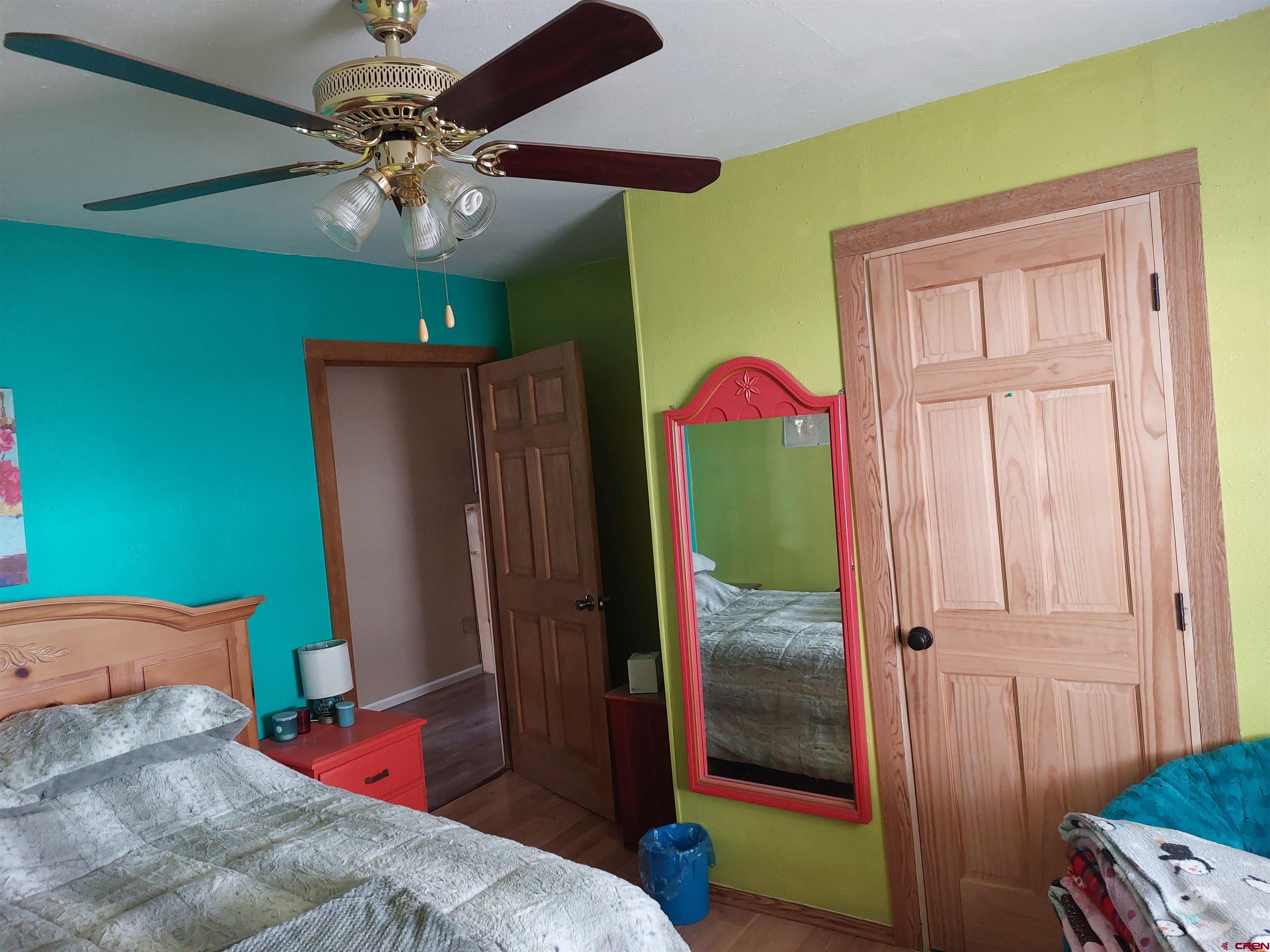 14663 Road N 3 Cahone Co 81320 Cahone, CO 81320 - Photo 12 of 20 a bedroom with a bed and a chandelier