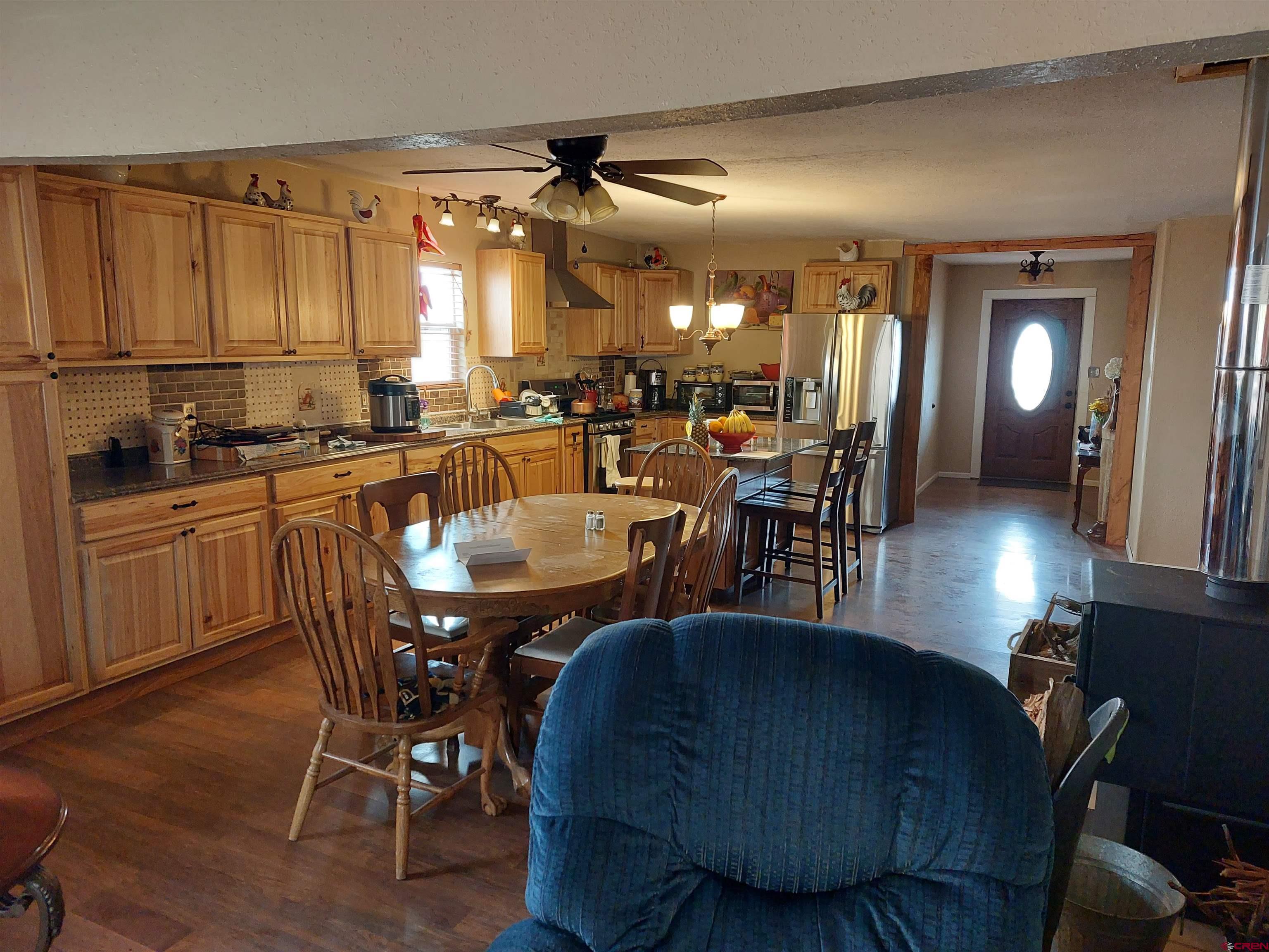 14663 Road N 3 Cahone Co 81320 Cahone, CO 81320 - Photo 5 of 20 a dining hall with furniture a window and wooden floor
