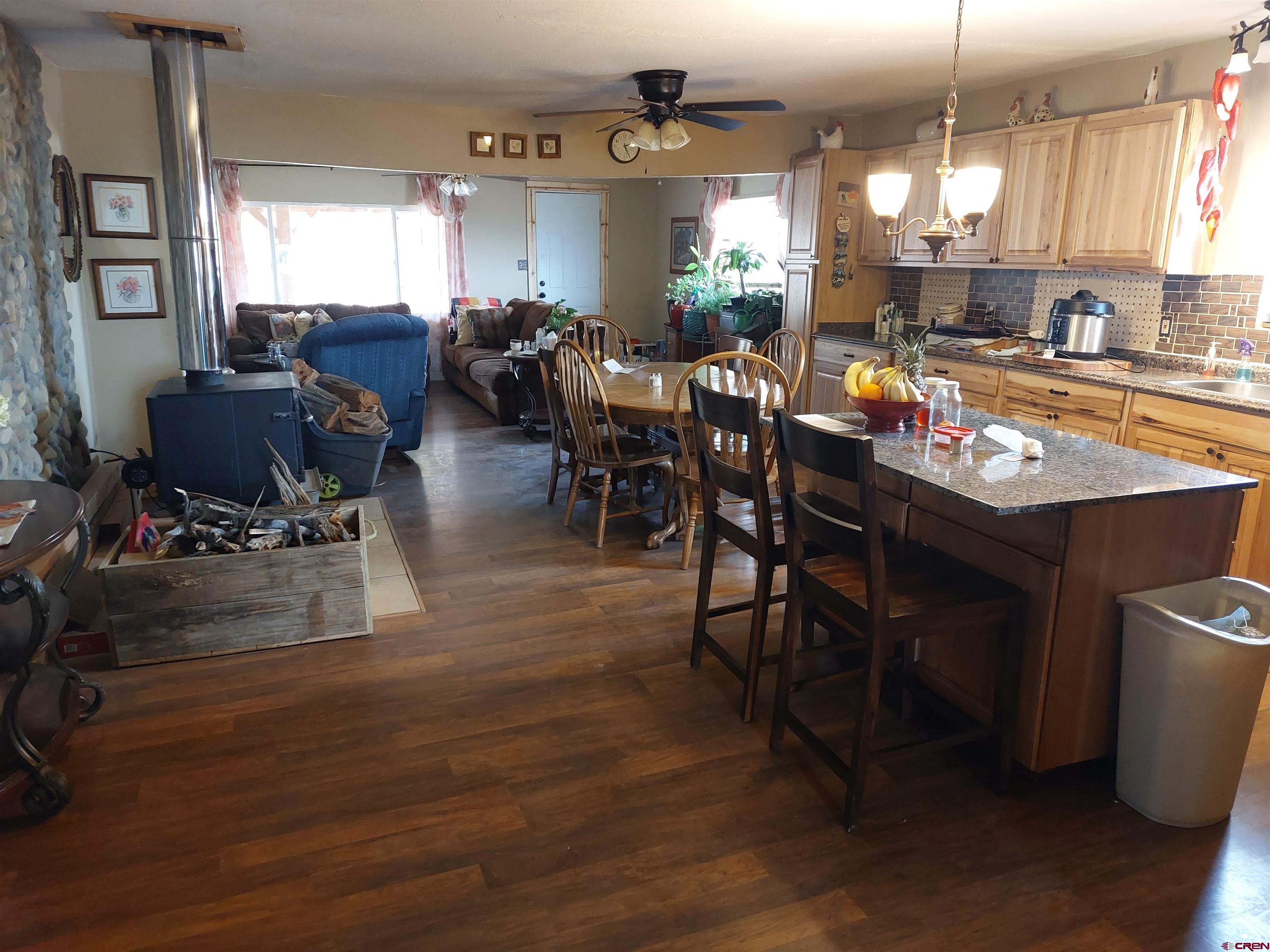 14663 Road N 3 Cahone Co 81320 Cahone, CO 81320 - Photo 6 of 20 a room with lots of wooden furniture dining table and a wooden floor
