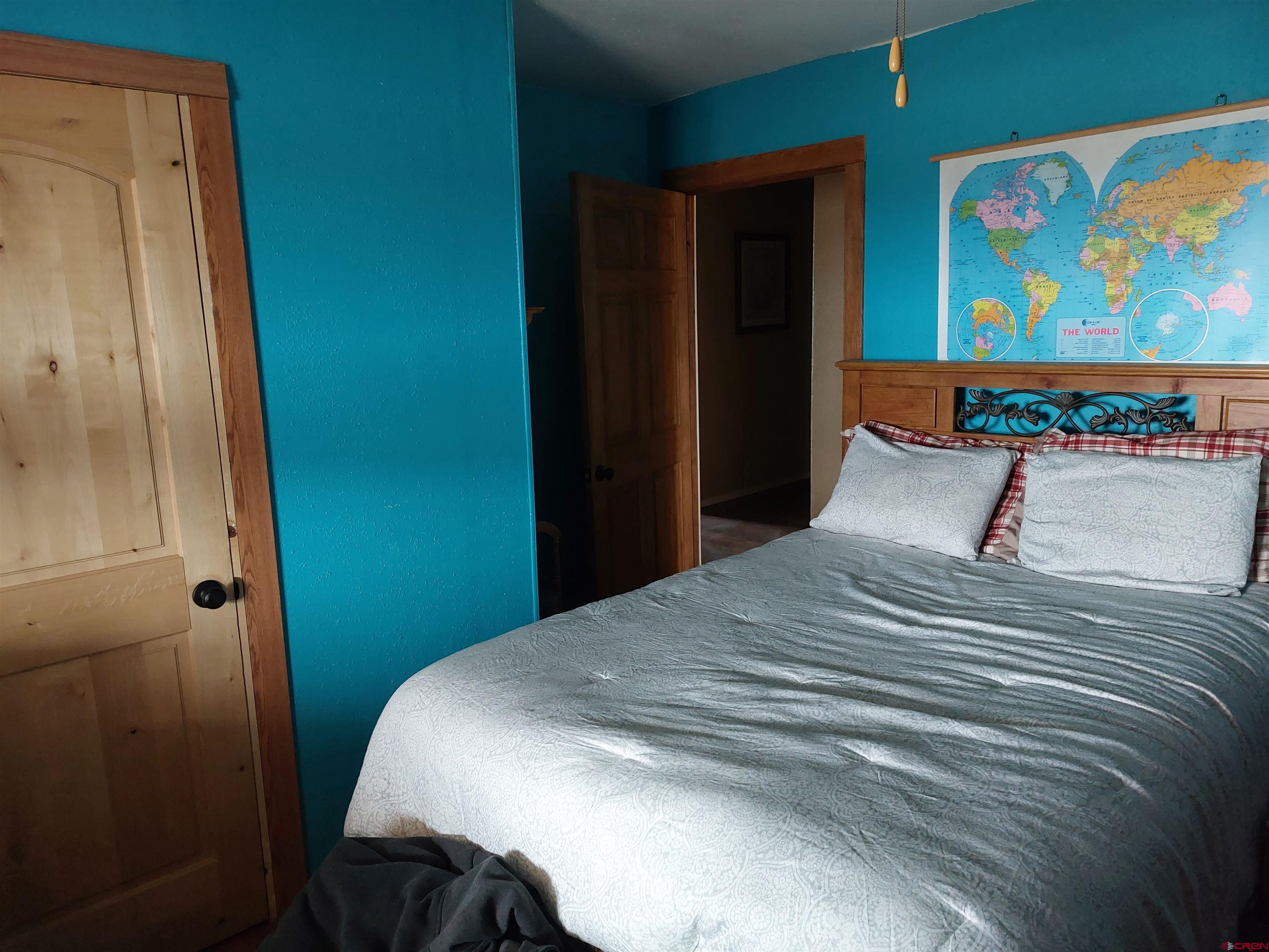 14663 Road N 3 Cahone Co 81320 Cahone, CO 81320 - Photo 7 of 20 a bedroom with a bed and painting on the wall