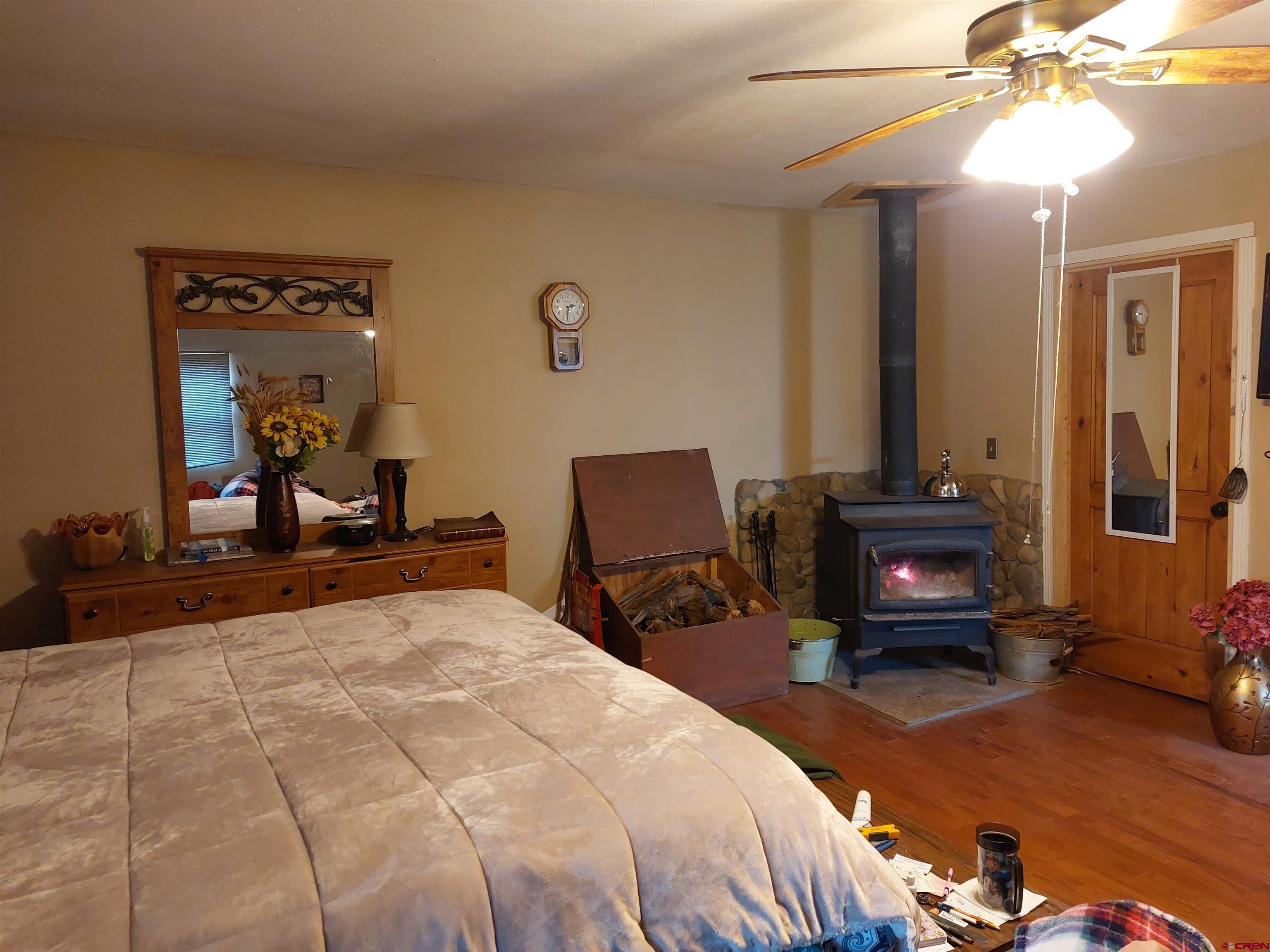 14663 Road N 3 Cahone Co 81320 Cahone, CO 81320 - Photo 9 of 20 a bedroom with a bed and a chandelier