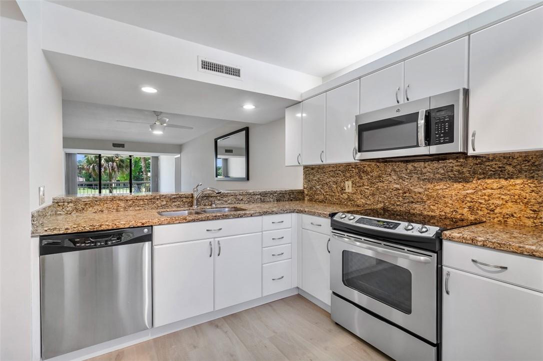 6181 Balboa Circle, Unit 201 Boca Raton, FL 33433 - Photo 16 of 32 Kitchen opens to dining and family room.