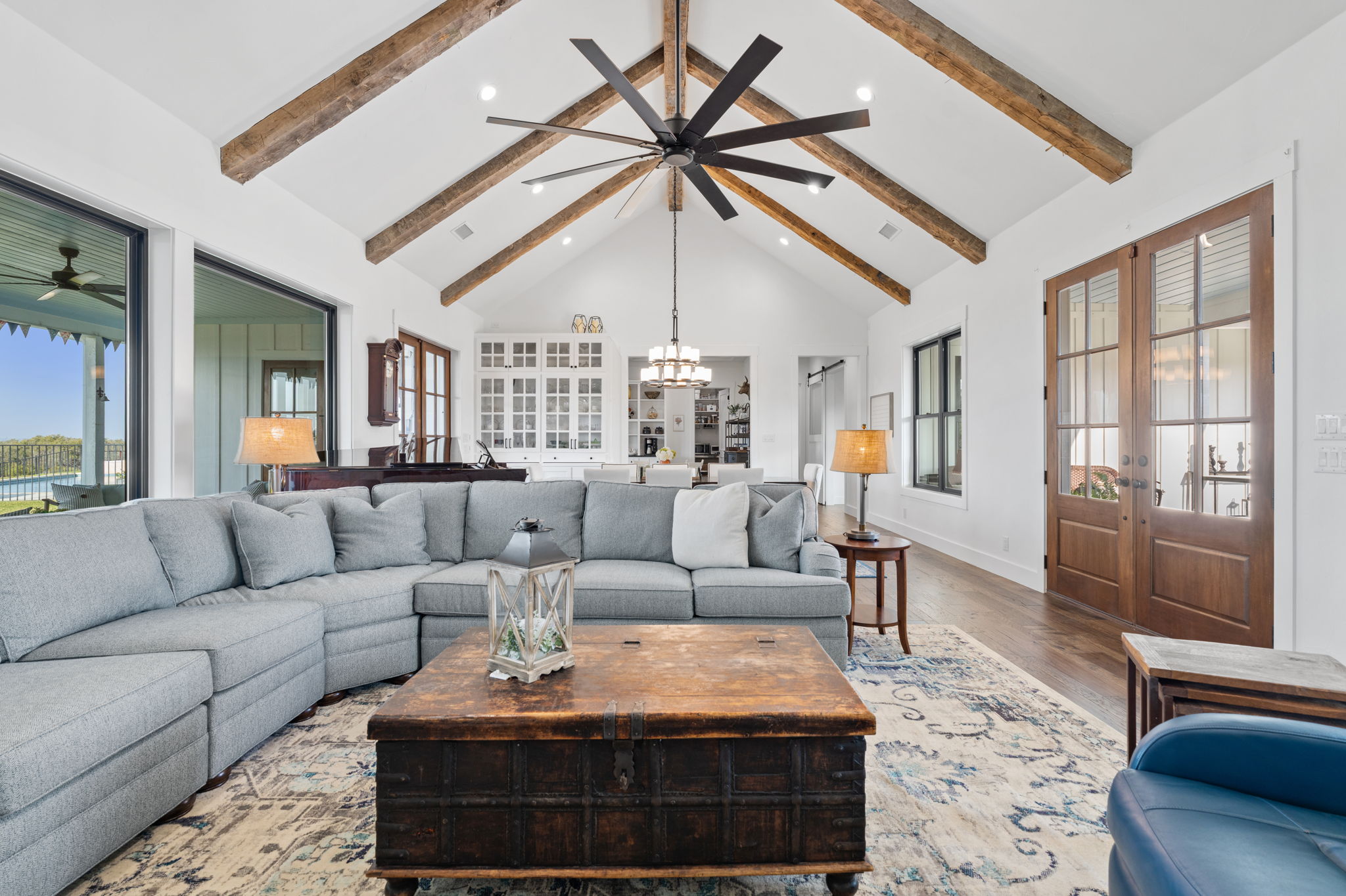 452 Southwick Ranch Road Johnson City, TX 78636 - Photo 10 of 40 Natural light pours into this grand living space with soaring vaulted ceilings and rich wood beams.