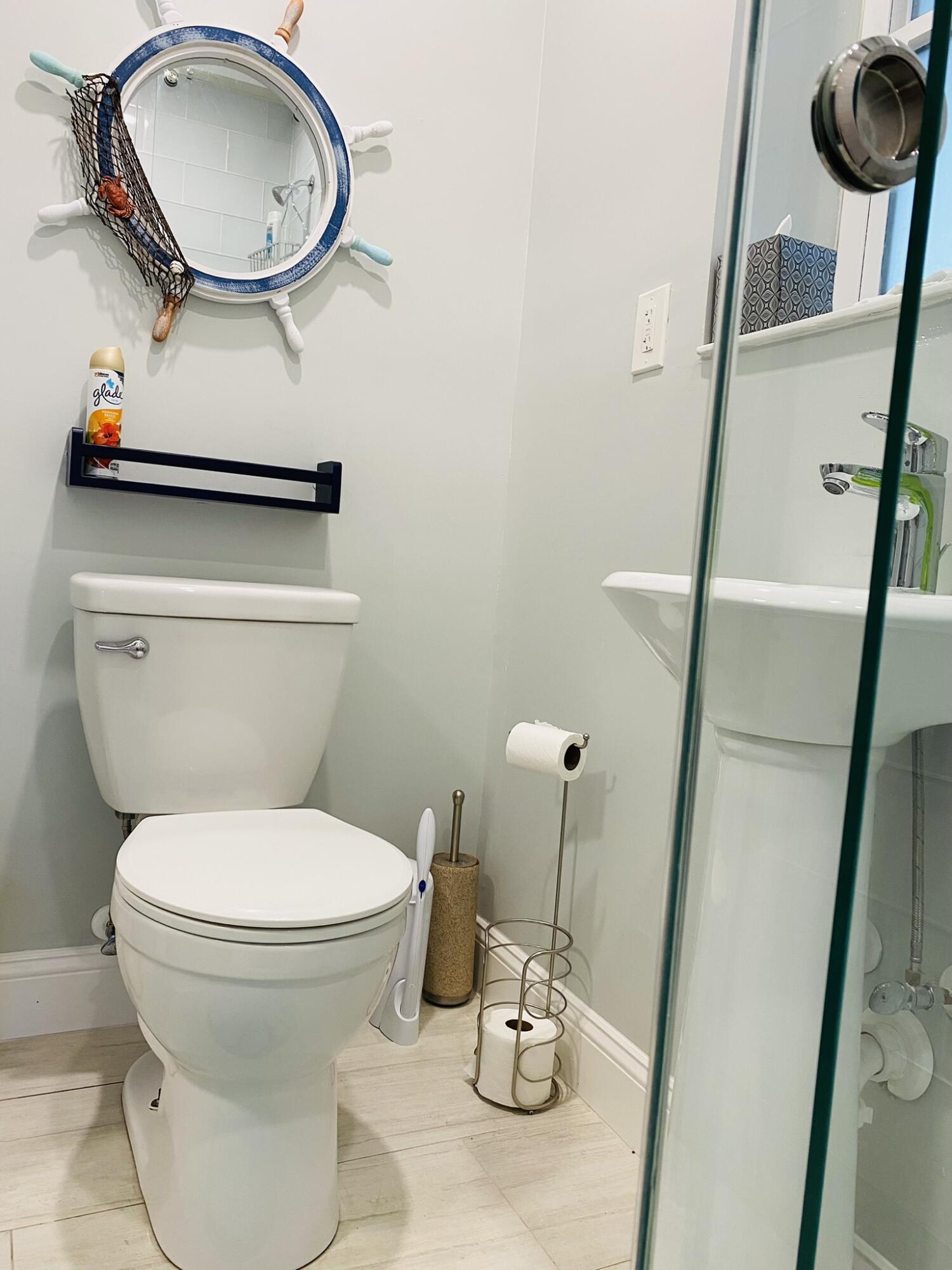 5501 North Ocean Boulevard Ocean Ridge, FL 33435 - Photo 13 of 21 a bathroom with a toilet and a mirror