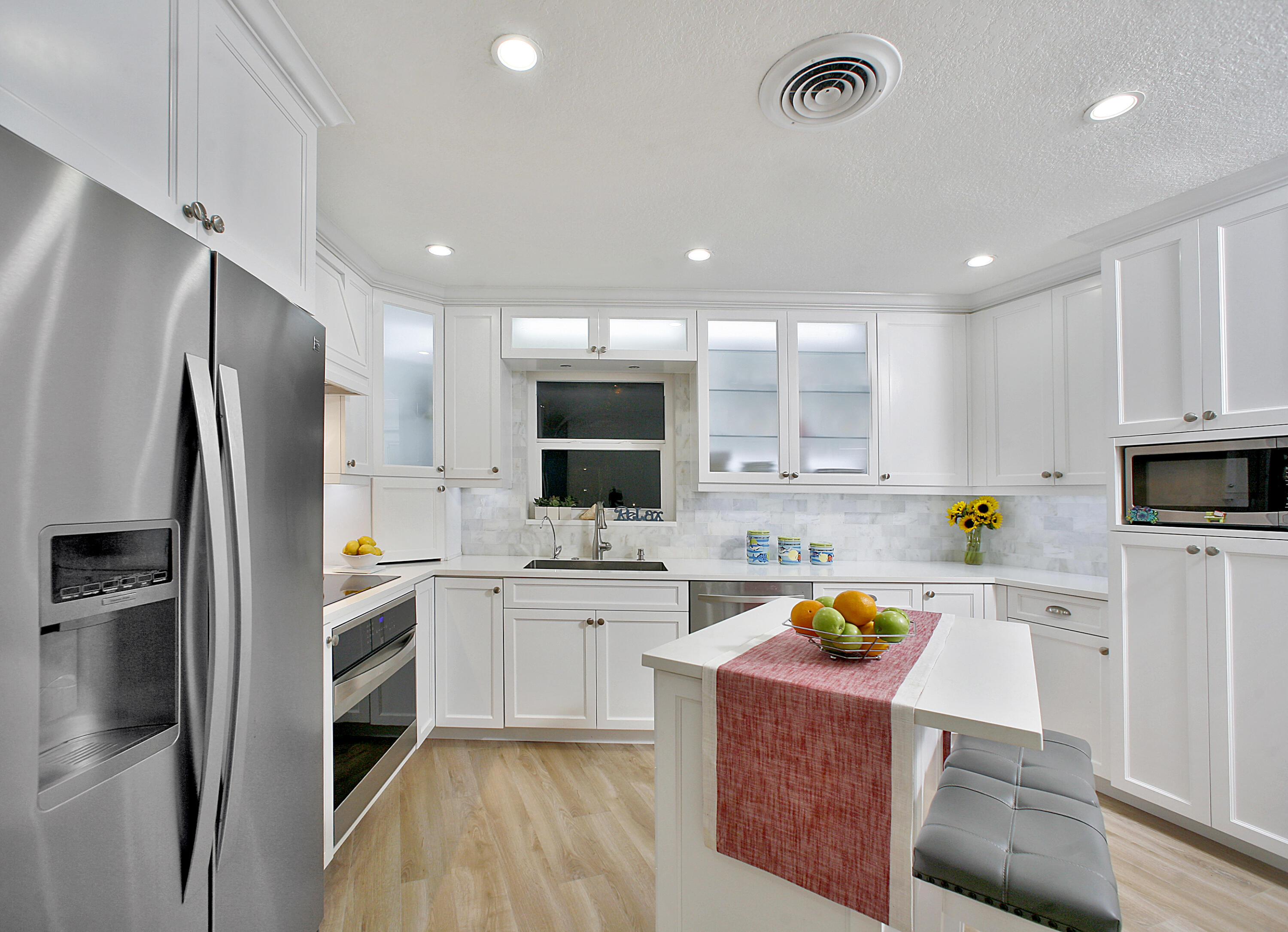 5501 North Ocean Boulevard Ocean Ridge, FL 33435 - Photo 3 of 21 a kitchen with a sink a refrigerator and white cabinets