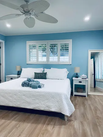 a bedroom with two beds and a chandelier