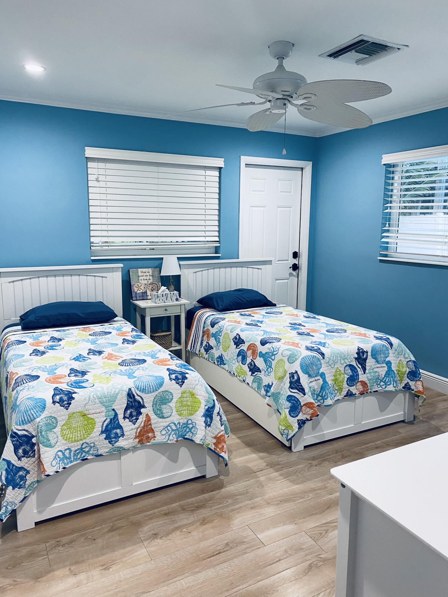 5501 North Ocean Boulevard Ocean Ridge, FL 33435 - Photo 6 of 21 a bedroom with two beds and a chandelier
