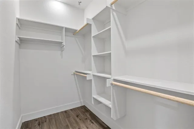 a view of walk in closet with empty racks